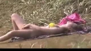 A young Asian masturbates out in a field A young Asian masturbates out in a field