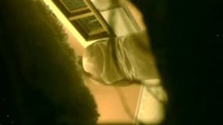 A naked woman in the bathroom being spied on