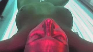 Brunette enjoying a tanning bed