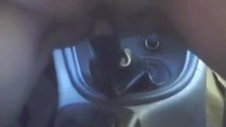 A mature woman sits on the gear stick!