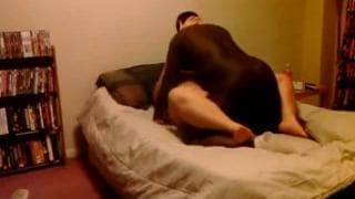 An interracial BBW fucking in bed An interracial BBW fucking in bed