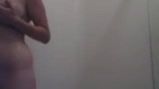 A brunette soaps up her body in the shower A brunette soaps up her body in the shower