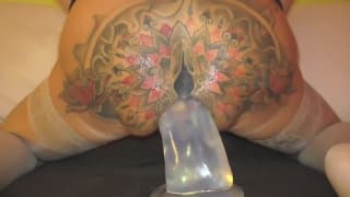 This woman slides on to a huge dildo This woman slides on to a huge dildo