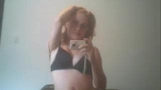 Redhead babe strips down to her lingerie Redhead babe strips down to her lingerie