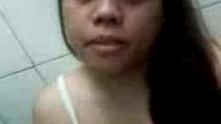 Slut masturbates in the public bathroom