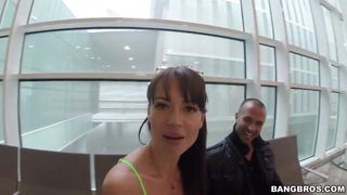 This busty brunette sucks cock in a parking lot