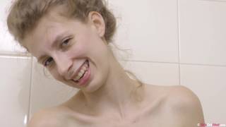 In the shower we see Alice urinating to save water. In the shower we see Alice urinating to save water.