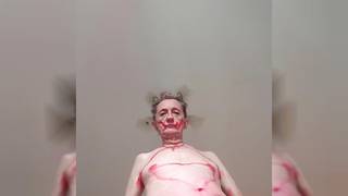 Gay old guy painting himself red and dances