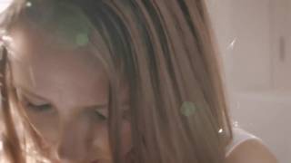 Busty teen girl touches herself in the light
