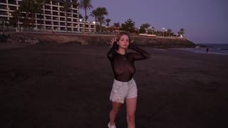 Her breasts mesmerize us as she strolls along the beach!