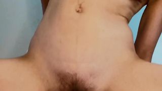 The brunette with the hairy pussy has fun in her chair touching herself